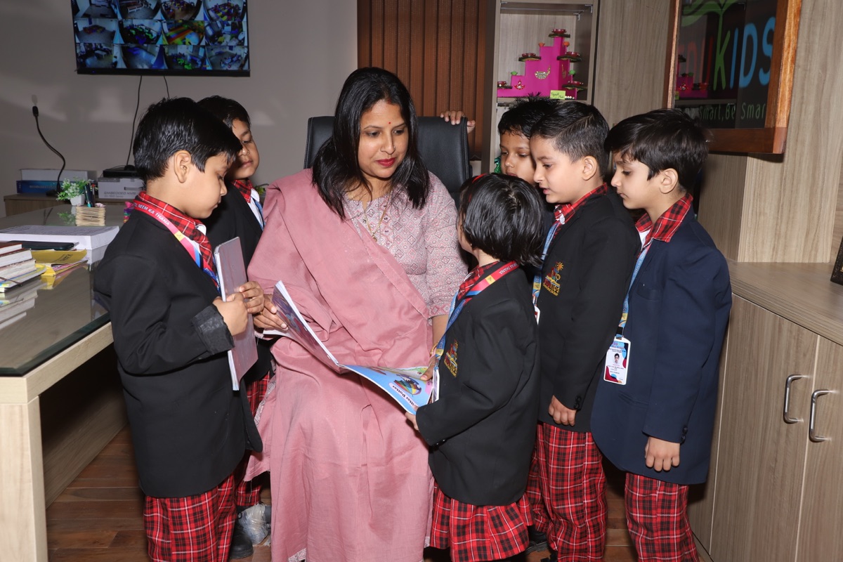 An EduKids teacher reading a picture book with two young children
